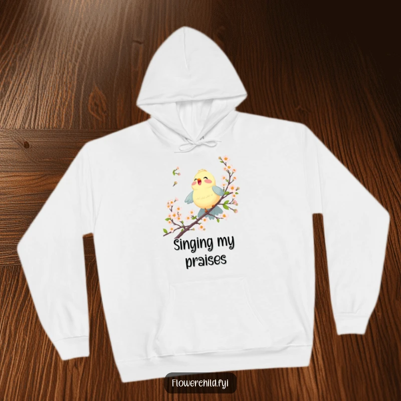 Funny hoodie showcasing a joyful bird singing amongst blossoming branches, offering comfort and cheerful design.